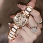 A generation of shaking audio and video number explosions sunflower hollow ladies watch ceramic white flywheel diamond watch women